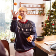 Man is aan het jongleren met fruit, één van zijn gezonde kerstcadeaus.